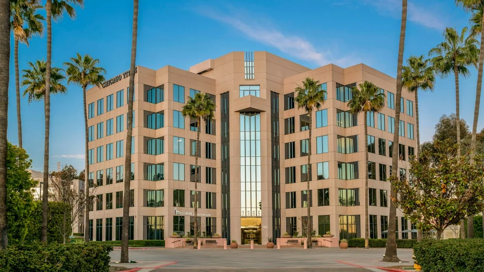Landscaped professional office building with palms, glass frontage and a prominent entrance